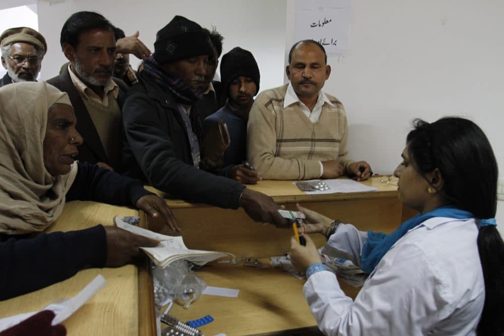 Pakistani family members of patients return medicines to a hospital in Lahore, Pakistan on Jan 23, 2012. Bad drugs were blamed for killing dozens. (K.M.Chaudary/AP)