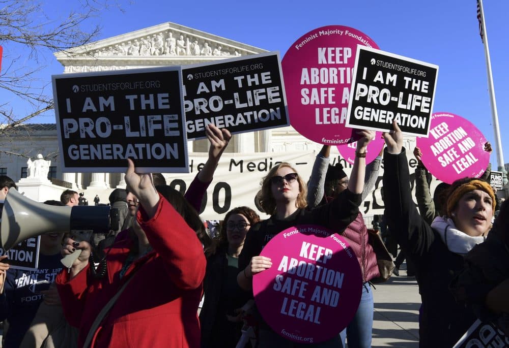 Protesters on both sides of the abortion issue gather outside the Supreme Court in Washington, Friday, Jan. 19, 2018, during the March for Life. (Susan Walsh/AP)