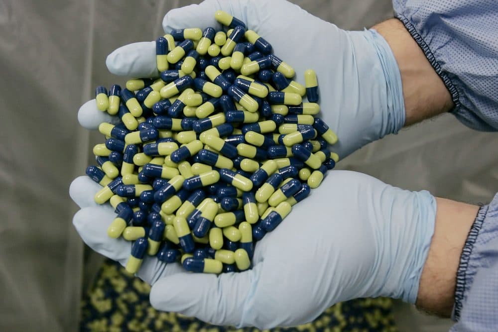 In this Jan. 25, 2006 file photo, a production technician at Eli Lilly and Company, examines Cymbalta 60mg pills in Indianapolis. (AP Photo/Darron Cummings, File)