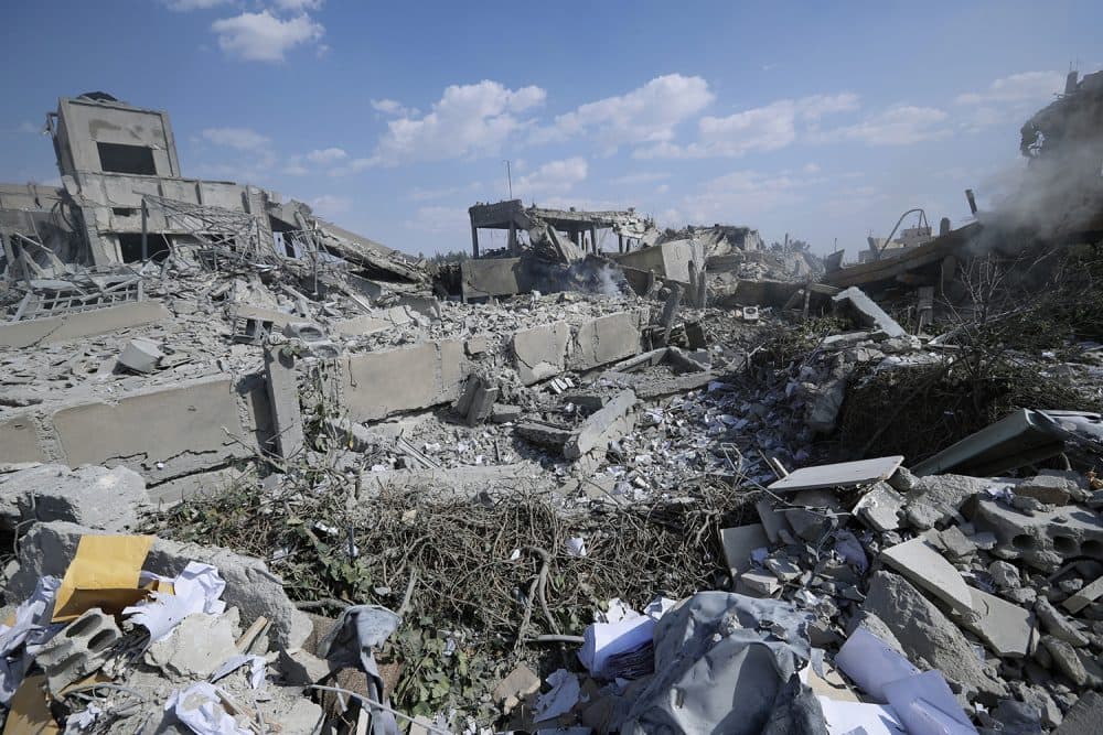 Debris surround the Syrian Scientific Research Center which was attacked by U.S., British and French military strikes to punish President Bashar Assad for suspected chemical attack against civilians, in Barzeh, near Damascus, Syria, Saturday, April 14, 2018. The Pentagon says none of the missiles filed by the U.S. and its allies was deflected by Syrian air defenses, rebutting claims by the Russian and Syrian governments. Lt. Gen. Kenneth McKenzie, the director of the Joint Staff at the Pentagon, also says there also is no indication that Russian air defense systems were employed early Saturday in Syria. (AP Photo/Hassan Ammar)