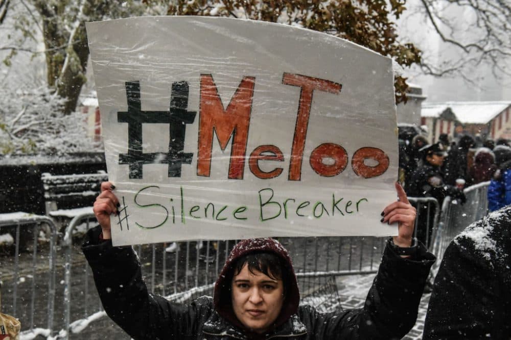 People carry signs addressing the issue of sexual harassment at a #MeToo rally outside of Trump International Hotel on Dec. 9, 2017 in New York City. (Stephanie Keith/Getty Images)