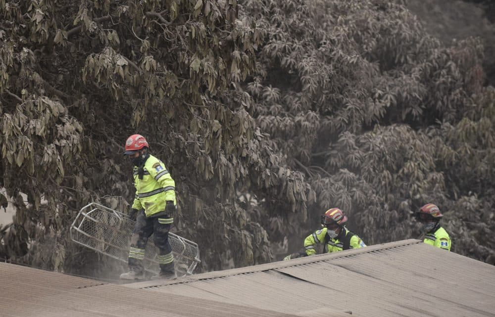 Rescuers search for victims in San Miguel Los Lotes, a village in Escuintla Department, about 35 kilometers southwest of Guatemala City, on June 4, 2018, a day after the eruption of the Fuego volcano. (Johan Ordonez/AFP/Getty Images)