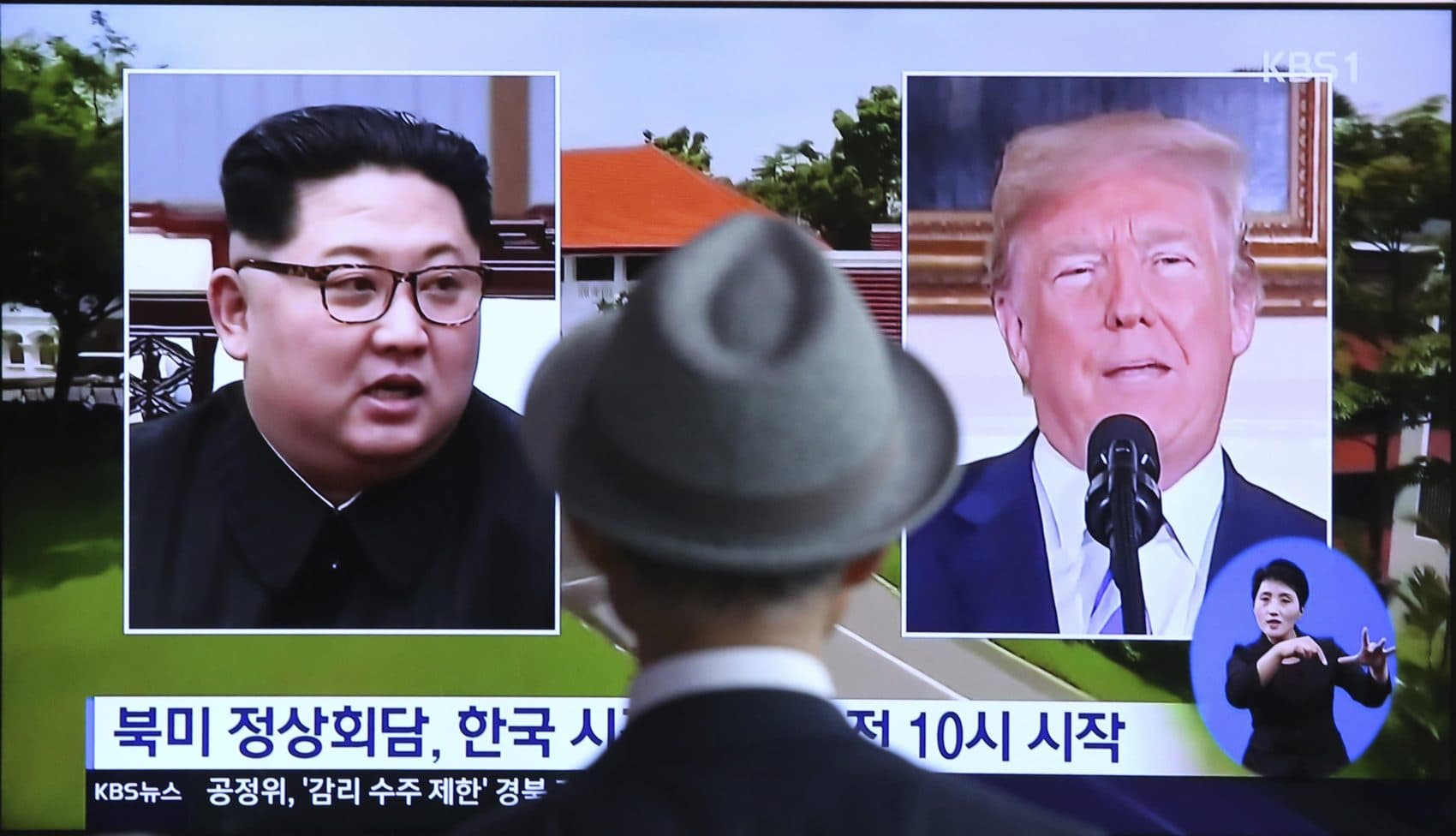 A man watches a TV screen showing file footage of U.S. President Donald Trump, right, and North Korean leader Kim Jong Un during a news program at the Seoul Railway Station in Seoul, South Korea, Monday, June 11, 2018. Final preparations are underway in Singapore for Tuesday's historic summit between President Trump and North Korean leader Kim, including a plan for the leaders to kick things off by meeting with only their translators present, a U.S. official said. The signs read: "Summit between the United States and North Korea." (Ahn Young-joon/AP)