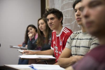 Students from prep schools run by Tecnologico de Monterrrey in Mexico in an English class at Pine Manor College in Brookline. (Jesse Costa/WBUR)