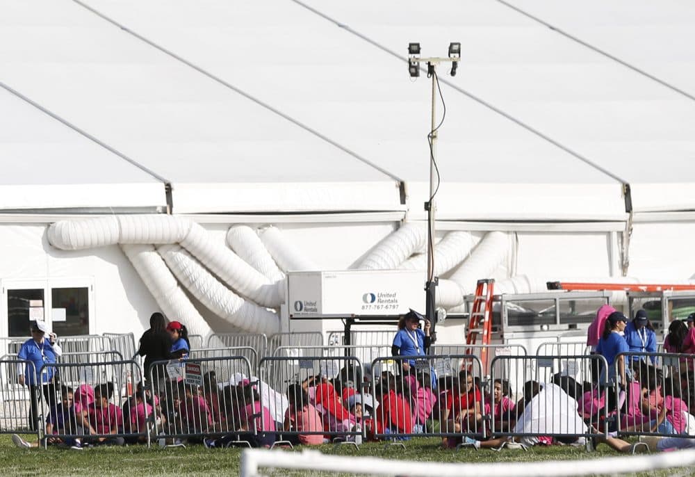 Immigrant children are shown outside a former Job Corps site that now houses them, Monday, June 18, 2018, in Homestead, Fla. It is not known if the children crossed the border as unaccompanied minors or were separated from family members. An unapologetic President Donald Trump defended his administration's border-protection policies Monday in the face of rising national outrage over the forced separation of migrant children from their parents. (Wilfredo Lee/AP)