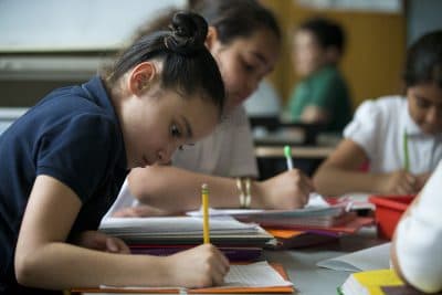 Third-grade students in a diverse classroom at Garfield Elementary School in Revere work on assignments in class. (Jesse Costa/WBUR)