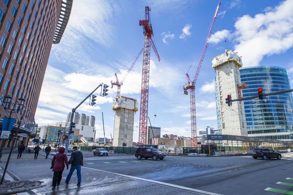 Cranes stretch into the sky in March over what will become three buildings of luxury apartments and condos. (Jesse Costa/WBUR)
