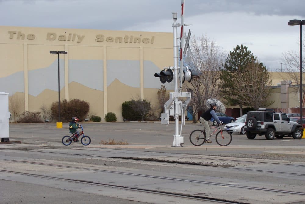 People bike past The Grand Junction Daily Sentinel in Grand Junction, Colo. (jimmy thomas/Flickr)