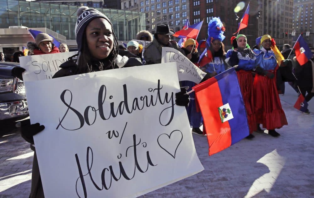 Haitian activists and immigrants protest on Boston City Hall Plaza on Jan. 26. (Charles Krupa/AP)