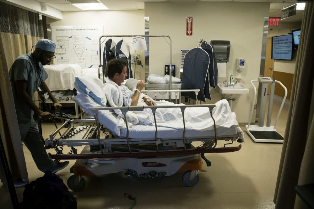 Ryan Ciccozzi is taken to surgery at the Hospital of the University of Pennsylvania in Philadelphia, Tuesday, Jan. 23, 2018. During Ciccozzi's surgery a fluorescent dye was used to find hidden cancer cells near his heart and in a lung. Surgery has long been the best way to cure cancer. Now, dyes are being tested to make cancer cells light up so doctors can cut them out and give patients a better shot at survival. (AP Photo/Matt Rourke)
