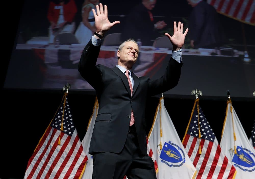 Gov. Charlie Baker acknowledges applause as he takes the stage to address the Massachusetts Republican Convention at the DCU Center in Worcester on April 28, 2018. (Winslow Townson/AP)