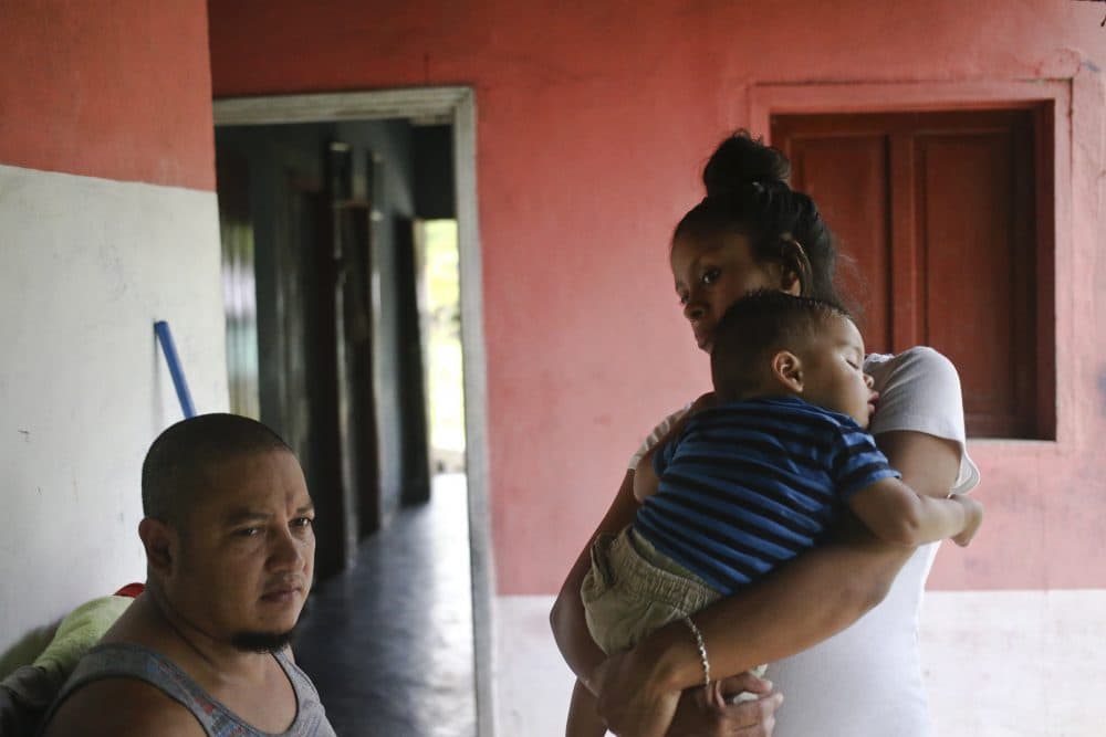 Adalicia Montecinos cradles her year-old son Johan, who became a poster child for the U.S. policy of separating immigrants and their children, during the first full day back with his family, in La Libertad, Honduras, Saturday, July, 21, 2018. Johan arrived in San Pedro Sula and was reunited with his parents on a government bus. Captured by Border Patrol agents in March, Johan's father was deported and the then 10-month-old remained at an Arizona shelter. Pictured at left is Johan's father Rolando Bueso Castillo. (Esteban Felix/AP)