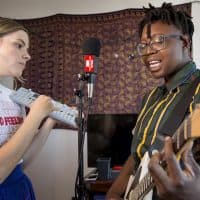 Photocomfort and Anjimile perform in Anjimile's apartment. (Robin Lubbock/WBUR)