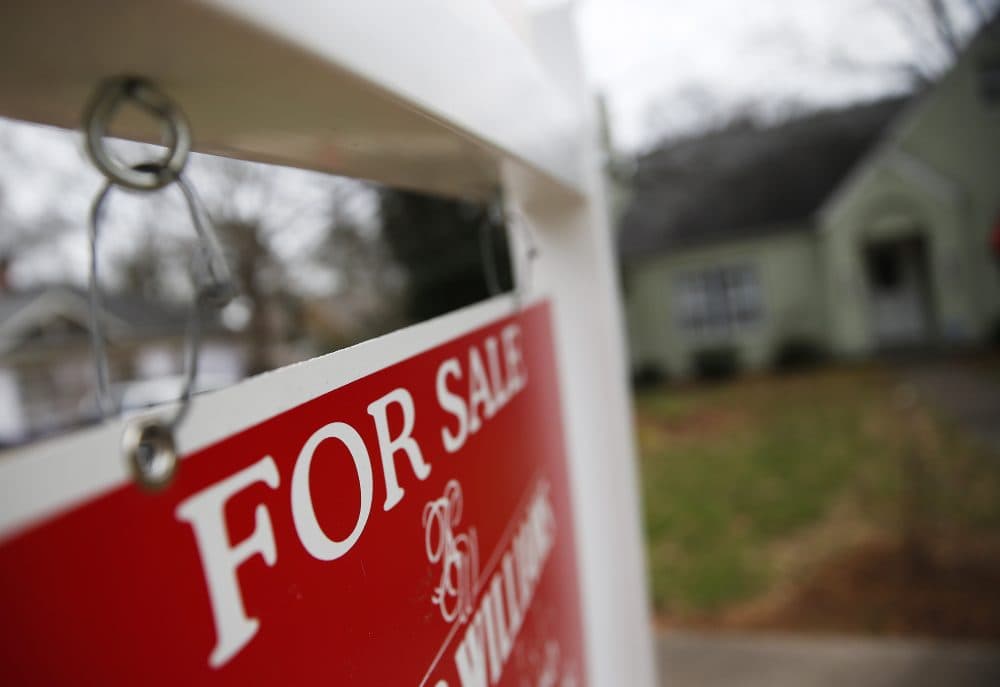 This Jan. 26, 2016 file photo shows a "For Sale" sign hanging in front of an existing home in Atlanta. Short of savings and burdened by debt, America's millennials are struggling to afford their first homes in the face of sharply higher prices in many of the most desirable cities. Surveys show that most Americans under 35 lack adequate savings for down payments. The result is that many will likely be forced to delay home ownership and to absorb significant debt loads if they do eventually buy. (John Bazemore, File/AP)
