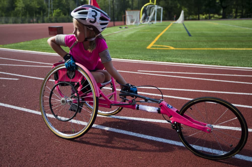Maddie Wilson looks behind her as Tatyana McFadden arrives at the track. (Jesse Costa/WBUR)