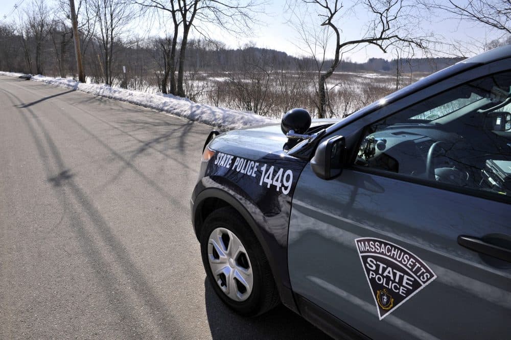 A state police vehicle sits on Water Row in in Wayland, Mass., Friday, Feb. 15, 2013. (AP Photo/The Boston Globe, Josh Reynolds, Pool)