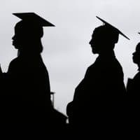 In this May 17, 2018, file photo, new graduates line up before the start of the Bergen Community College commencement at MetLife Stadium in East Rutherford, N.J. Obtaining a college degree has increasingly coincided with ever-higher student debt loads. Since 2004, total student debt has climbed more than 540 percent to $1.4 trillion, according to the New York Federal Reserve. (Seth Wenig, File/AP)