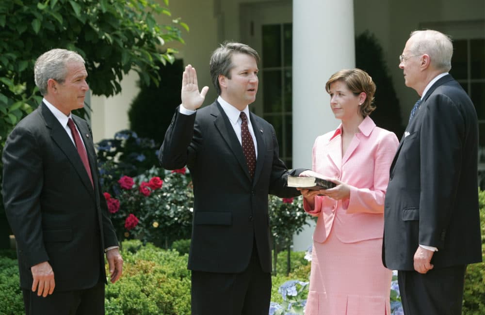 In this June 1, 2006 file photo, from left to right, President Bush, watches the swearing-in of Brett Kavanaugh as Judge for the U.S. Court of Appeals for the District of Columbia by U.S. Supreme Court Associate Justice Anthony M. Kennedy, far right, during a ceremony in the Rose Garden of the White House, in Washington. (Pablo Martinez Monsivais/AP)