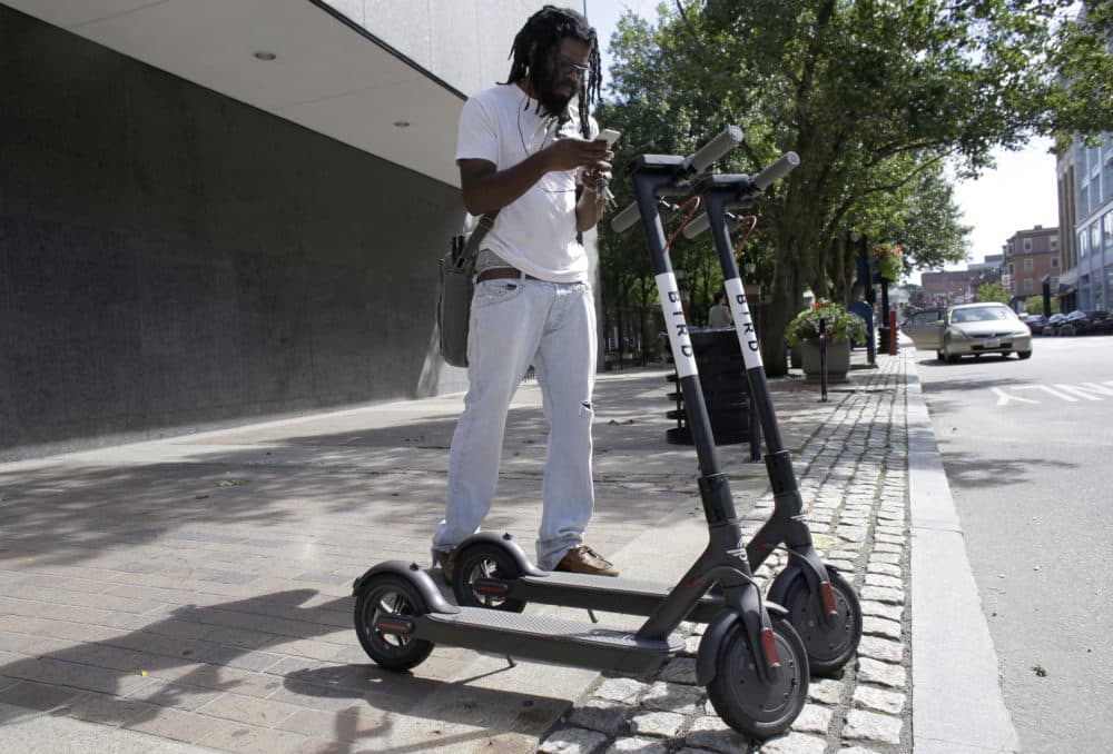 Vatic Kuumba, of Providence, R.I., prepares to ride a Bird electric scooter in downtown Providence Tuesday, July 24, 2018. (Steven Senne/AP)