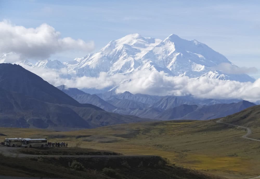 In this photo taken Aug. 26, 2016, sightseeing buses and tourists are seen at a pullout popular for taking in views of North America's tallest peak, Denali, in Denali National Park and Preserve, Alaska. (Becky Bohrer/AP)