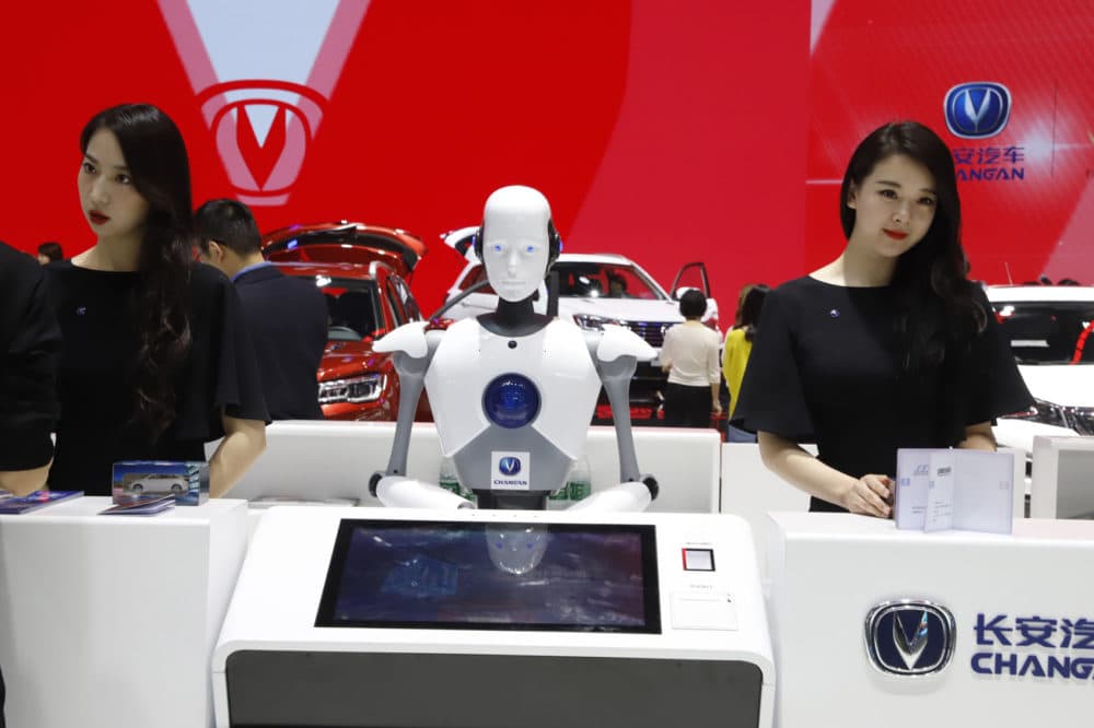 FILE - In this April 26, 2018, file photo, a robot assist receptionist is seen at the booth of a Chinese automaker during the China Auto 2018 show in Beijing, China. Under President Xi Jinping, a program known as "Made in China 2025" aims to make China a tech superpower by advancing development of industries that in addition to semiconductors includes artificial intelligence, pharmaceuticals and electric vehicles. (AP Photo/Ng Han Guan, File)