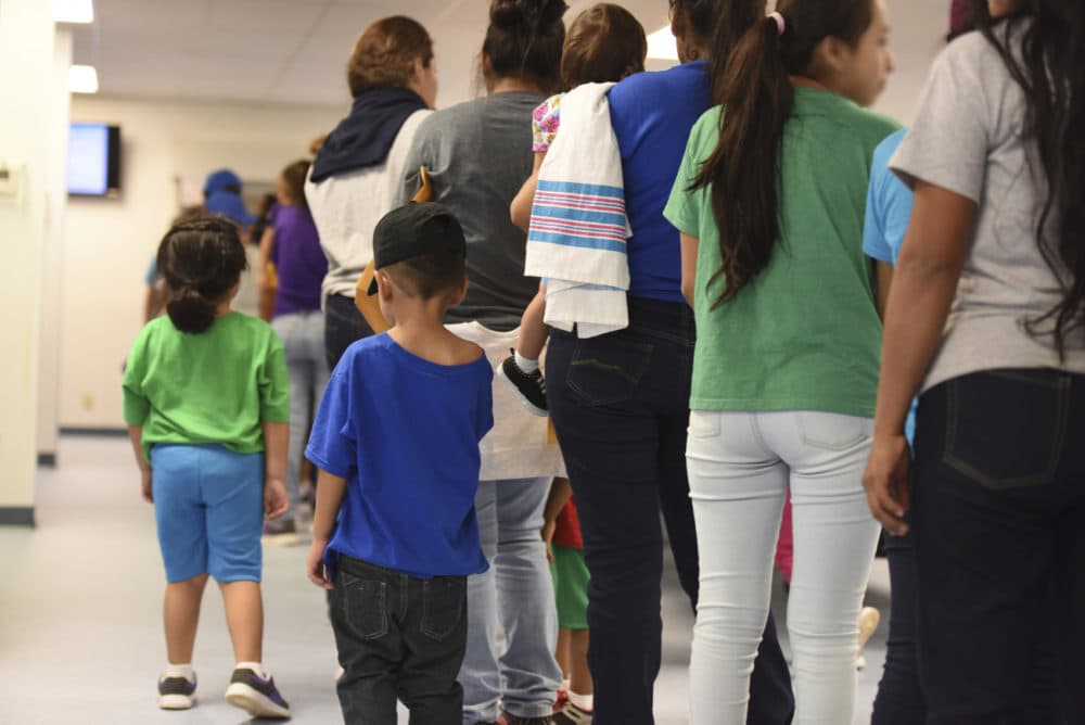 In this Thursday, Aug. 9, 2018, photo, provided by U.S. Immigration and Customs Enforcement, mothers and their children stand in line at South Texas Family Residential Center in Dilley, Texas. Currently housing 1,520 mothers and their children, about 10 percent are families who were temporarily separated and then reunited under a zero tolerance policy that has since been reversed. (Charles Reed/U.S. Immigration and Customs Enforcement via AP)