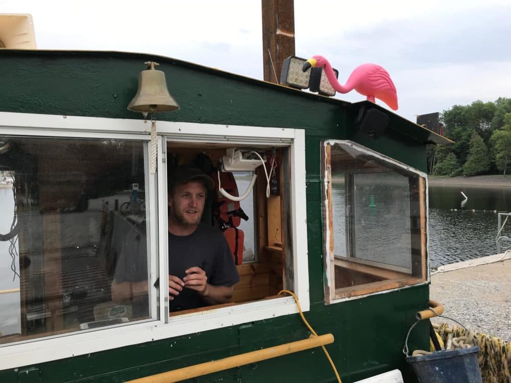Lucas Campbell operates one of the few landing crafts on Lake Champlain. Here, he readies the boat to take off from Burton Island State Park. (Henry Epp/VPR)