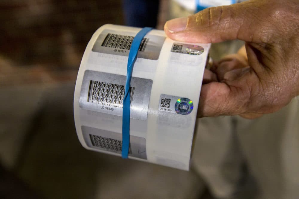 The hologram labels that are placed on all authenticated items have a reference number and QR code that can be checked online at the MLB's website. (Jesse Costa/WBUR)