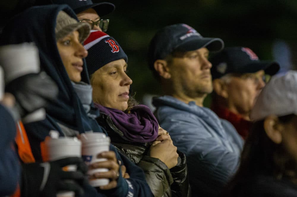 Despite the temperatures dropping into the 40's, Red Sox fans watch intently during the game. (Jesse Costa/WBUR)