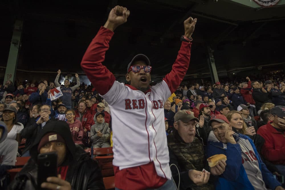 A Red Sox fan cheers as Chris Sale strikes out Dodgers batter Brian Dozier for the first out of the night. (Jesse Costa/WBUR)