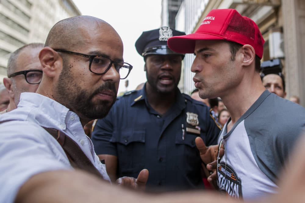 A police officer separates a pro Trump supporter, right, who was taunting one of the organizers of the "100 Days of Failure" protest and march, Saturday, April 29, 2017, in New York. (Mary Altaffer/AP)