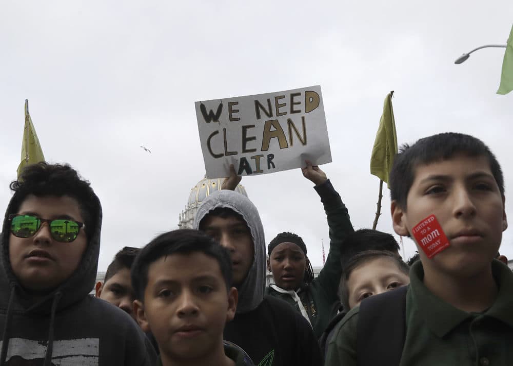 Students listen to speakers at a rally for clean energy in San Francisco, Wednesday, Feb. 28, 2018. California stands in "complete opposition" to a Trump administration plan to scrap a policy slashing climate-changing emissions from power plants. (Jeff Chiu/AP)