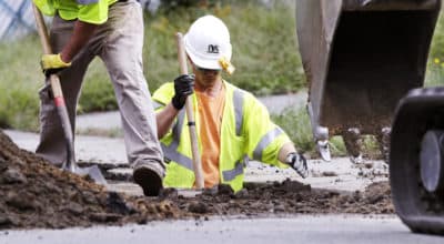 Utility contractors dig up the road above natural gas lines along Dracut Street in Lawrence, Mass., Thursday, Sept. 20, 2018 after the explosions in the Merrimack Valley area serviced by Columbia Gas of Massachusetts. (Charles Krupa/AP)