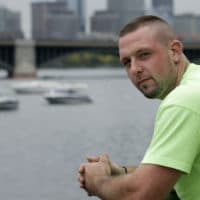 In this Monday, Oct. 1, 2018 photo Michael Robinson, of North Reading, Mass., in recovery from heroin addiction, stands for a photo near the Charles River, in Cambridge. Robinson recently became a union carpenter and has been working on building projects across the Boston area since. (Steven Senne/AP)