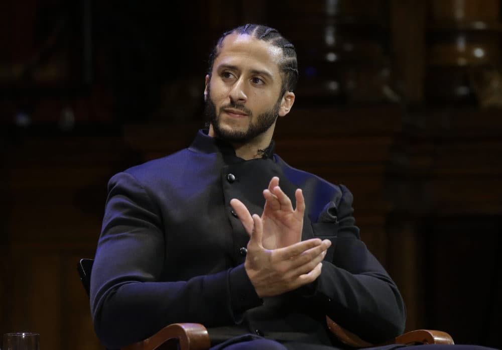 Former NFL football quarterback Colin Kaepernick applauds while seated on stage during W.E.B. Du Bois Medal ceremonies, Thursday, Oct. 11, 2018, at Harvard University, in Cambridge, Mass. Kaepernick is among eight recipients of Harvard University's W.E.B. Du Bois Medals in 2018. Harvard has awarded the medal since 2000 to people whose work has contributed to African and African-American culture.(AP Photo/Steven Senne)