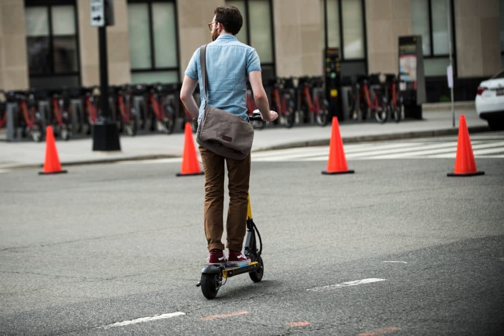 A man rides an electric scooter on the street of downtown Washington D.C. on June 21, 2018. (Eric Baradat/AFP/Getty Images)
