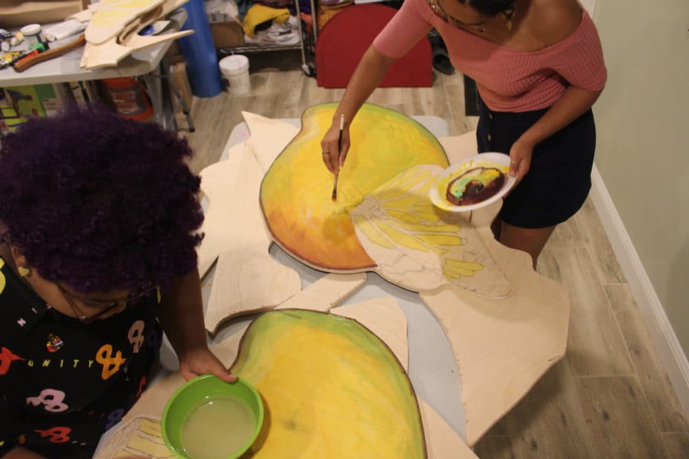 Artists Chanel Thervil, left, and Iris Lapaix prepare for "Mariposas and Mangos." (Arielle Gray for WBUR)