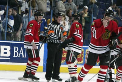 Players congratulate referee Paul Stewart on his 1,000th NHL game. (Elsa/Getty Images/NHLI)