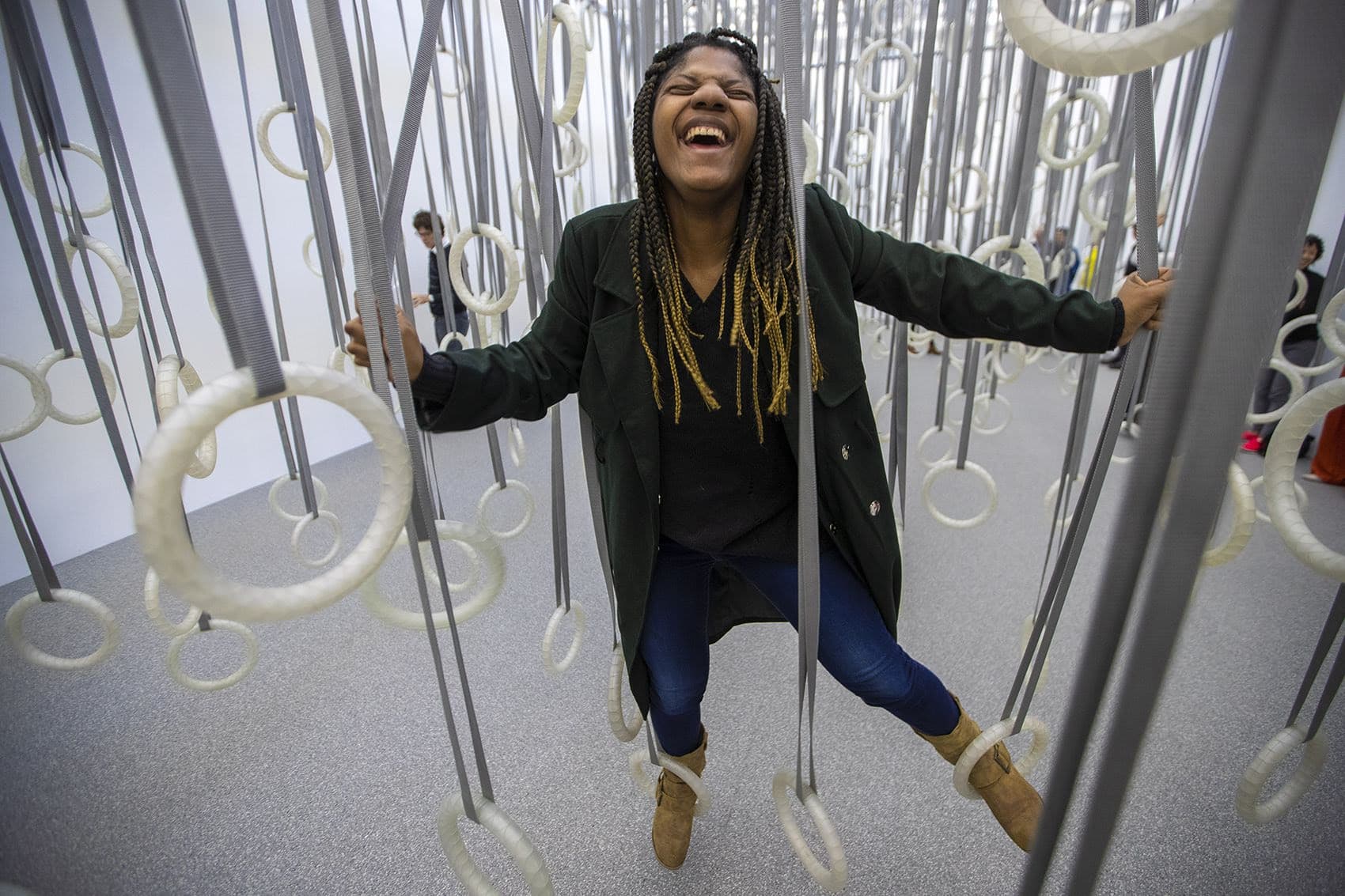 At the &quot;William Forsythe: Choreographic Objects&quot; exhibit at the ICA, Niya Doyle enjoys herself climbing through the installation ”The Fact of Matter,” where viewers are invited to traverse the space only using the dozens of rings suspended from the ceiling. (Jesse Costa/WBUR)