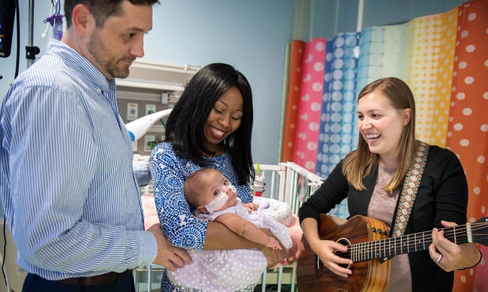 Hannah Ivey Bush plays guitar for Aubree Lynn Rosenberger and her parents, LaWanda and Jason Rosenberger, at the NICU at Children’s Healthcare of Atlanta at Scottish Rite. (Courtesy of Kipper Bush Photography)