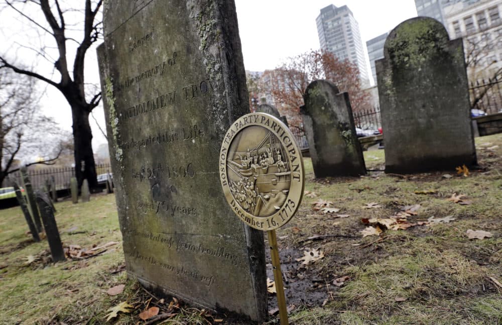 A commemorative marker stands at Central Burying Ground on Boston Common at the gravesite of Bartholomew Trow, a participant of the Boston Tea Party. (Elise Amendola/AP)