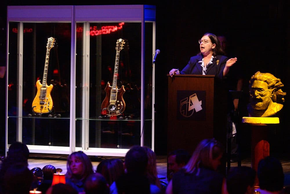 Guernsey's auctioneer Joanne Grant conducts bidding on guitars previously owned by the late Jerry Garcia during an auction on May, 8, 2002, at Studio 54 in New York. The guitar named Wolf, left, sold for $700,000 and Tiger sold for $850,000. (Chad Rachman/AP)
