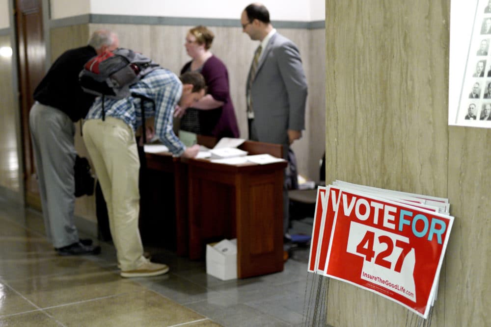 On Oct. 16, yard signs are stacked outside a public hearing in Lincoln, Neb., for Initiative 427, the Medicaid Expansion Initiative. The expansion passed in this week's elections. (Nati Harnik/AP)