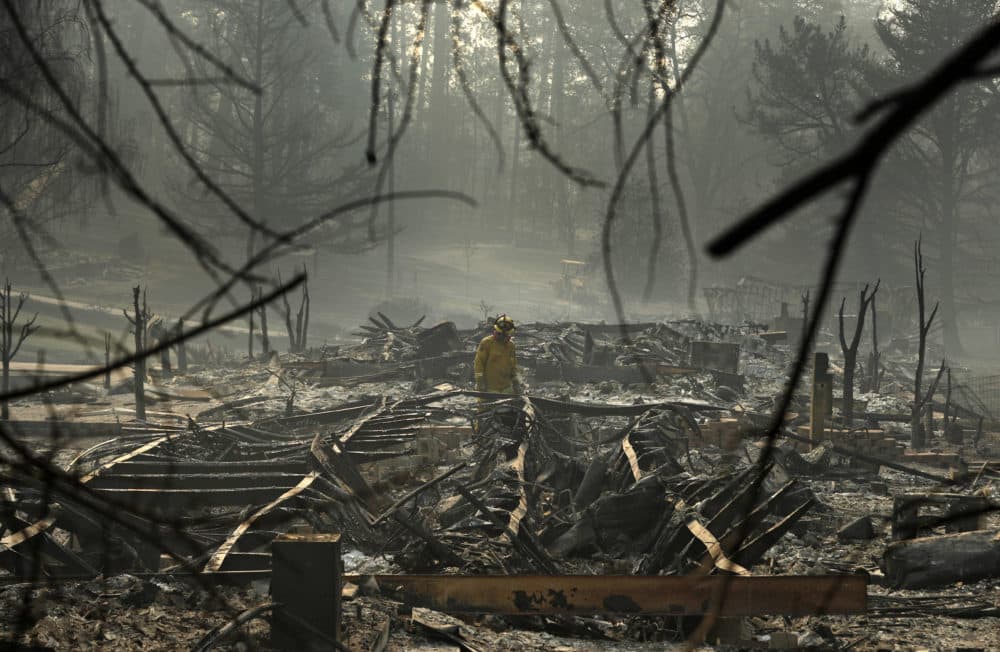 A firefighter searches for human remains in a trailer park destroyed in the Camp Fire, Friday, Nov. 16, 2018, in Paradise, Calif. (John Locher/AP)