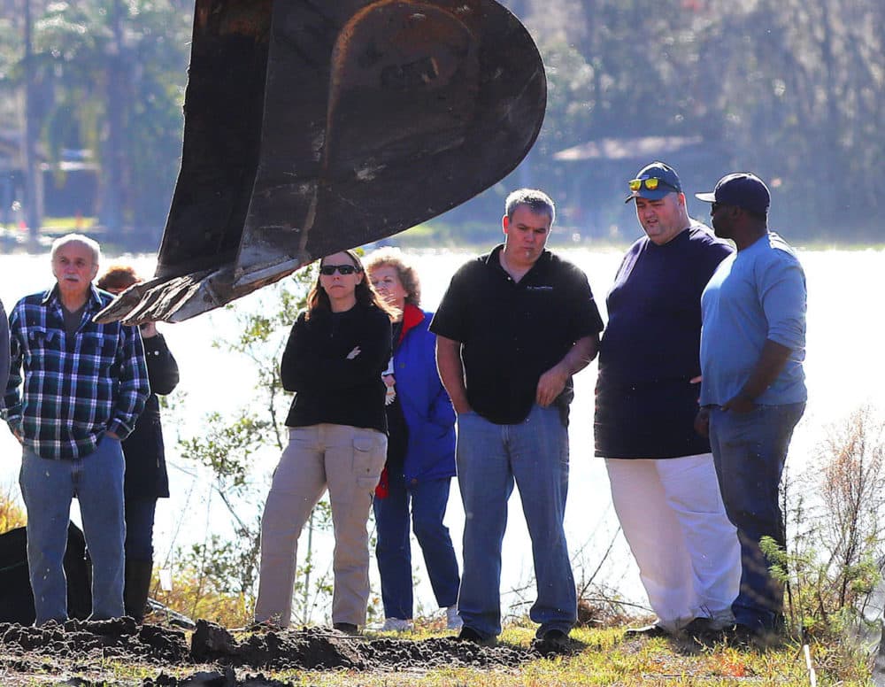 Brad Dupke, the only among the group wearing white pants, watches with FBI investigators as a lot is excavated in hopes of finding the stolen Isabella Stewart Gardner Museum artwork. (John Tlumacki/Globe Staff)