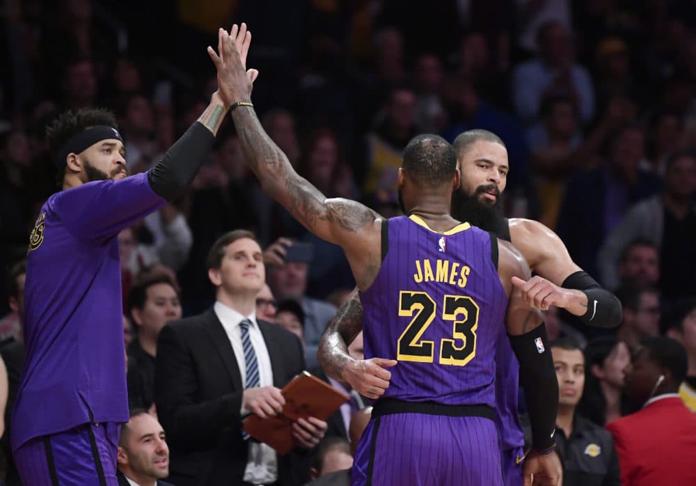 Los Angeles Lakers forward LeBron James is congratulated by teammates after he passed Wilt Chamberlain for fifth place in career points on Wednesday. (Mark J. Terrill/AP)