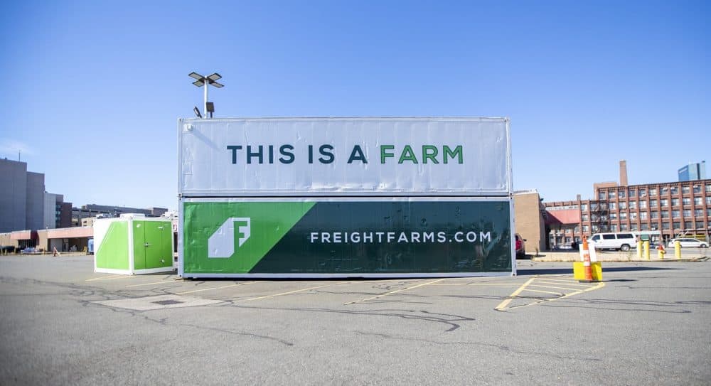 Two Freight Farms Leafy Green Machines sit stacked in a parking lot near their headquarters in the South End of Boston. (Jesse/CostaWBUR)