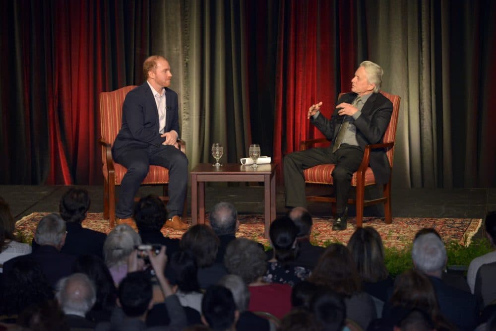 Michael Douglas talks with Here & Now's Jeremy Hobson at Boston University's Howard Gotlieb Archival Research Center. (Courtesy of Allan Dines Photography/Boston University)