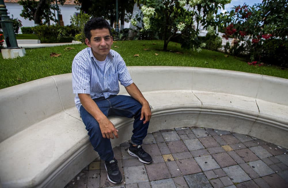 Orlando sentado en una plaza en Metapán, El Salvador. (Jesse Costa/WBUR)