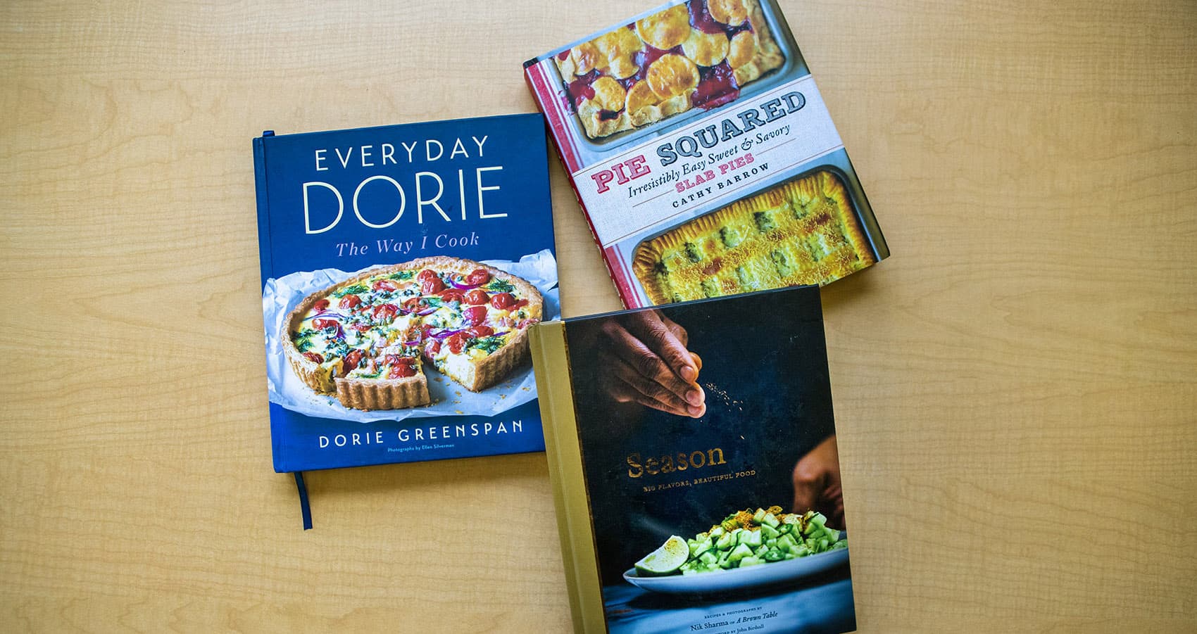 Three of chef Kathy Gunst's favorite cookbooks of 2018: "Pie Squared: Irresistibly Easy Sweet & Savory Slab Pies," by Cathy Barrow; "Everyday Dorie: The Way I Cook," by Dorie Greenspan; "Season: Big Flavors, Beautiful Food," by Nik Sharma. (Jesse Costa/WBUR)